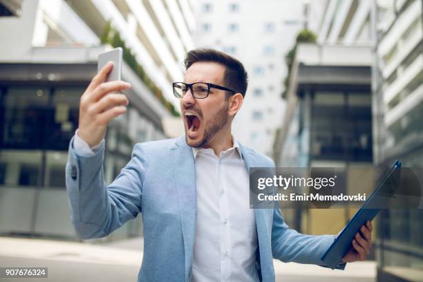 businessman on the phone shouting - shouting phone stock pictures, royalty-free photos & images