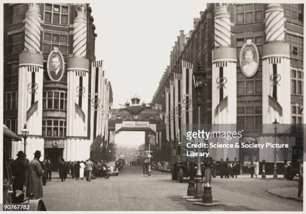 Photograph of King Street in Birmingham, West Midlands, taken by an unknown photographer in May 1937. The street has been decorated to celebrate the...