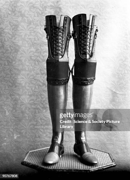 Studio photograph of a pair of artificial legs. The legs were manufactured by James Gillingham , a boot- and shoemaker based in Chard, Somerset....