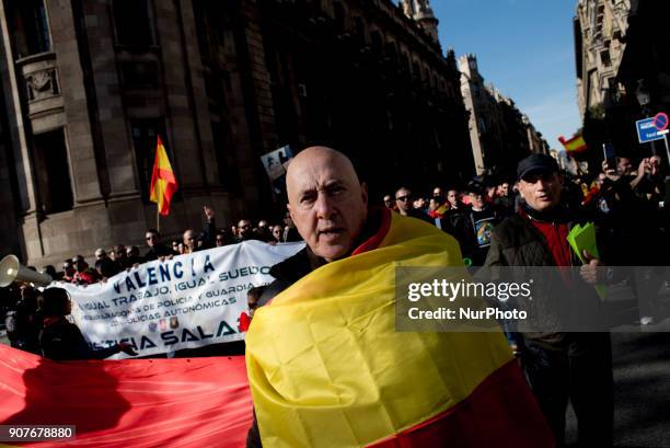 In Barcelona, Catalonia, Spain a man wrapped with a Spanish flag marches during a protest by police officers on 20 January, 2018. Thousands of police...