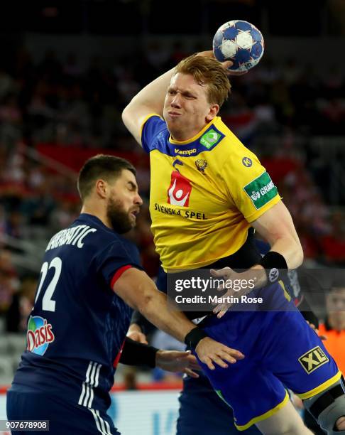 Simon Jeppson of Sweden challenges Luka Karabatic of France during the Men's Handball European Championship main round match between Sweden and...