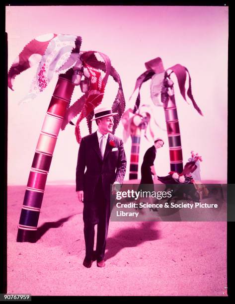 Colour transparency of a man and woman superimposed onto a beach, by Photographic Advertising Limited. With palm trees made from cotton reels,...