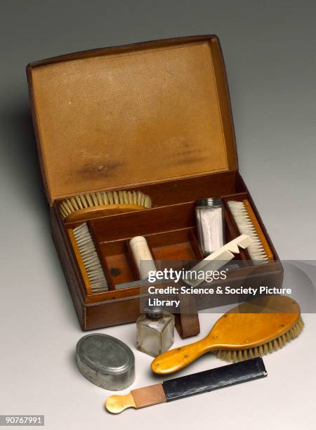 Case comprising two clothes brushes, two hair brushes, two open razors, nail trimming knife, scissors, botton hook, mirror, strop , comb, hair oil...