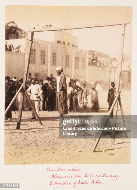 Public execution outside the railway station in Alexandria. A small crowd has gathered to view this gruesome scene. This man was executed for the...
