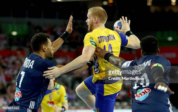Jim Gottfridsson of Sweden challenges Adrien Dipanda of France during the Men's Handball European Championship main round match between Sweden and...