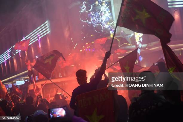 Vietnamese celebrate in downtown Hanoi after their team defeated Iraq during the Asian AFC U23 Championship football match being hosted in China on...