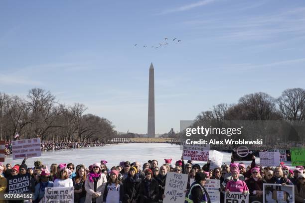 People gather at the Lincoln Memorial reflecting pool to rally before the Women's March on January 20, 2018 in Washington, DC. Across the nation...