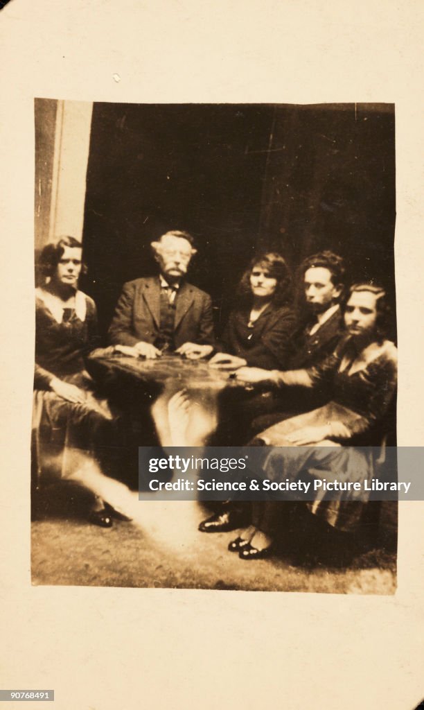 A seance, c 1920.