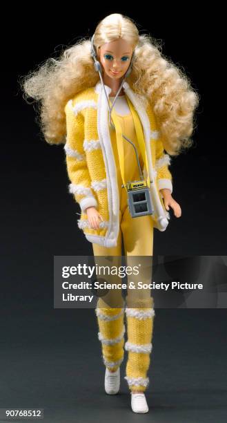 The plastic Barbie doll, made by Mattel, with walkman in yellow outfit.