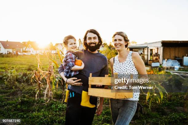 portrait of urban farming family together at their plot - self sufficiency fotografías e imágenes de stock