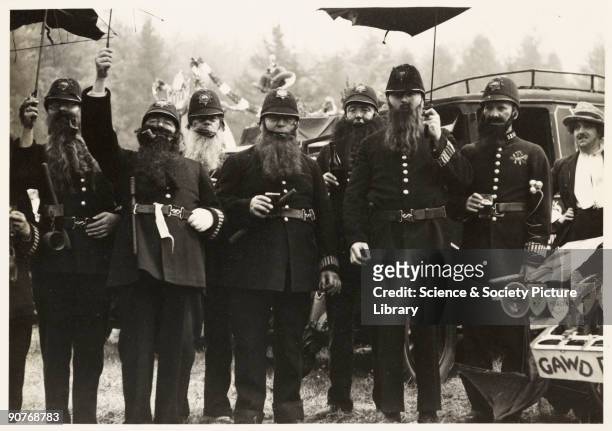 Photograph of a group of men dressed as comical police constables, taken by an unknown photographer in May 1937. The men were taking part in a fancy...