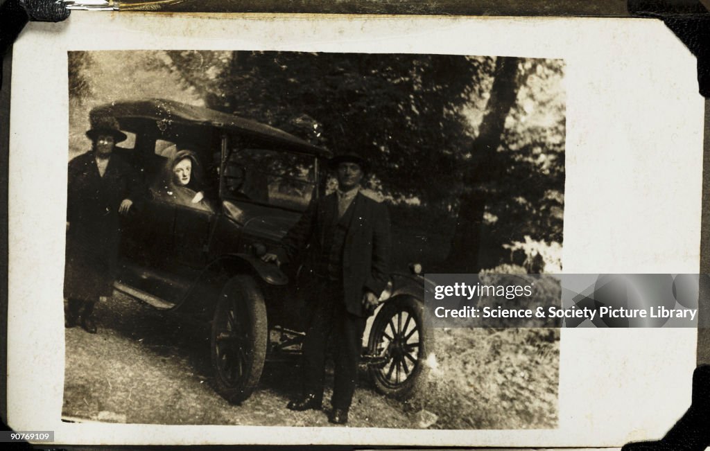Couple with a spirit in their car, c 1920..