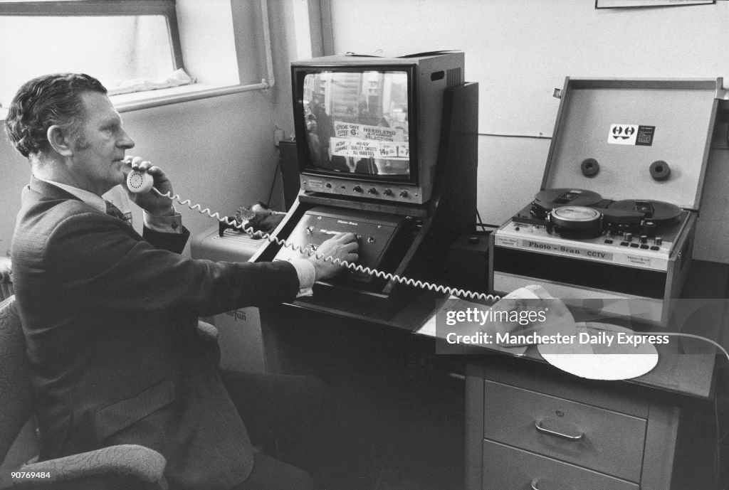 Security officer watching closed-circuit TV in a supermarket, January 1975.