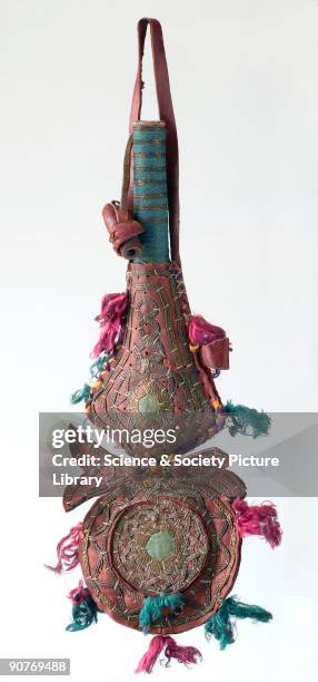 Red leather kohl container with a pear-shaped body, tubular cane neck, circular pendant suspended from the base with a mirror inset, and silver and...