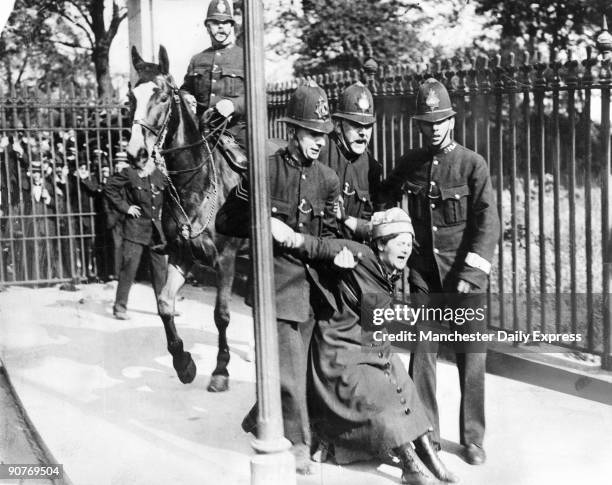 Woman campaigning for the vote is restrained by policemen. British women did not win full voting rights until 1928.