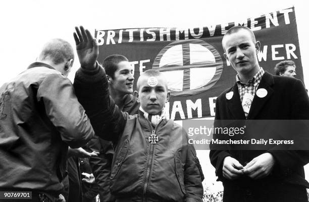 Skinhead with a sticker on his forehead: �Stop this Multi-racial Madness�. The British Movement banner behind advocates �White Power�.