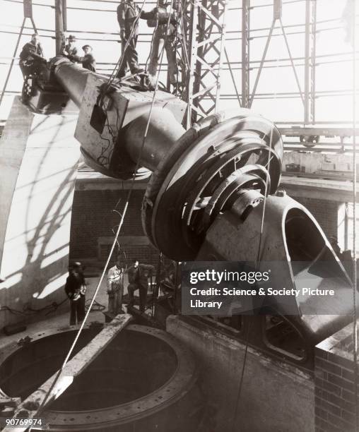 Photograph showing the mounting of the 74 inch reflecting telescope being assembled in the dome of the Radcliffe Observatory at Pretoria in South...