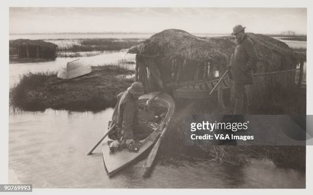 Photograph by Peter Henry Emerson showing men with their catch of birds.