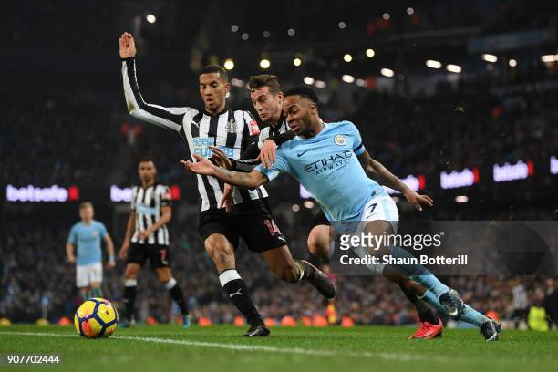 Raheem Sterling of Manchester City is tackled by Javi Manquillo of Newcastle United and a penalty is awarded during the Premier League match between...