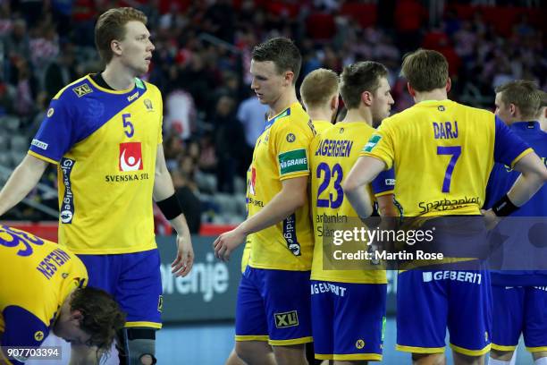 Team members of Sweden look dejected after the Men's Handball European Championship main round match between Sweden and France at Arena Zagreb on...