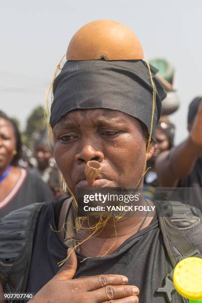 Togolese woman dressed in black takes to the streets of the capital Lome during a protest rally against Togo's president on January 20, 2018. A...