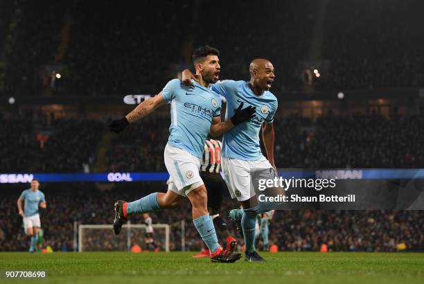 Sergio Aguero of Manchester City celebrates scoring his side's third goal with Fernandinho during the Premier League match between Manchester City...