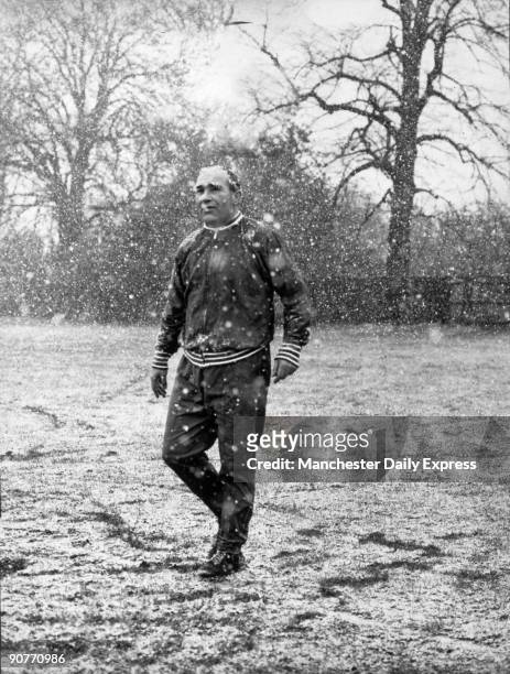 Photograph of Sir Alf Ramsey , England football manager, on the training ground in the snow, 2 April 1968. Ramsey played football for Southampton and...