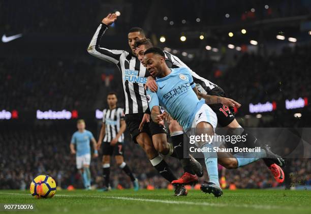 Raheem Sterling of Manchester City is tackled by Javi Manquillo and Isaac Hayden of Newcastle Unitedduring the Premier League match between...