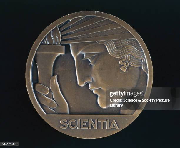Bronze medal engraved by P Turin showing a female face, left-facing, looking at a radiating torch. The reverse side of the coin shows a statue of a...