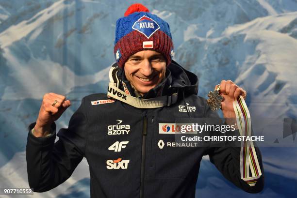 Poland's Kamil Stoch poses with his silver medal after placing second in the individual competition of the ski-flying world championships in...