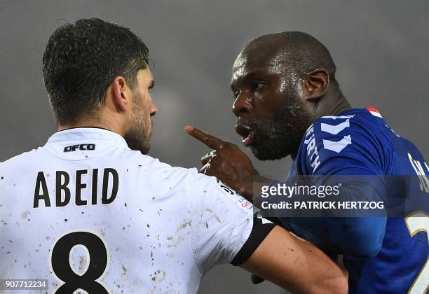 Strasbourg's French defender Ernest Seka argues with Dijon's French-Algerian midfielder Mehdi Abeid during the French Ligue 1 football match between...