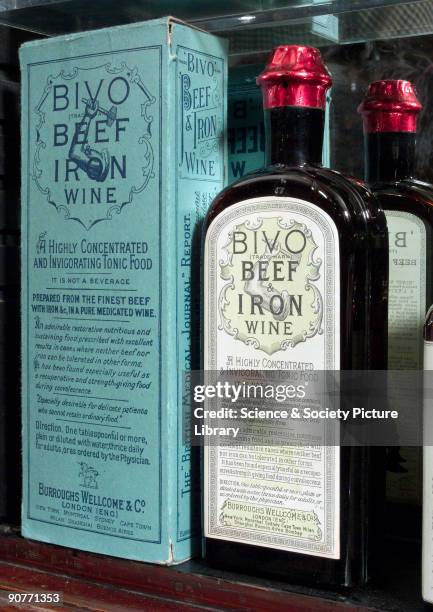 Two bottles of Bivo beef and iron wine, one in the original box packaging, shown in a counter top display case. Part of a shop fitting from The Old...