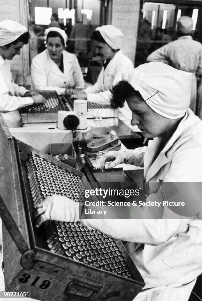 Women on a production line in a factory manufacturing the antibiotic penicillin at Speke, Liverpool.