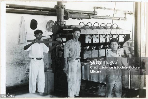 Image from the S. Pearson & Son Collection of the Tampico case and can factory in Mexico. Photograph of workers filling the cans, March 1920.
