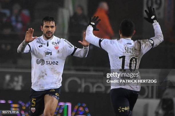 Dijon's French-Algerian midfielder Mehdi Abeid celebrates with Dijon's French-Tunisian midfielder Naim Sliti after scoring a goal during the French...