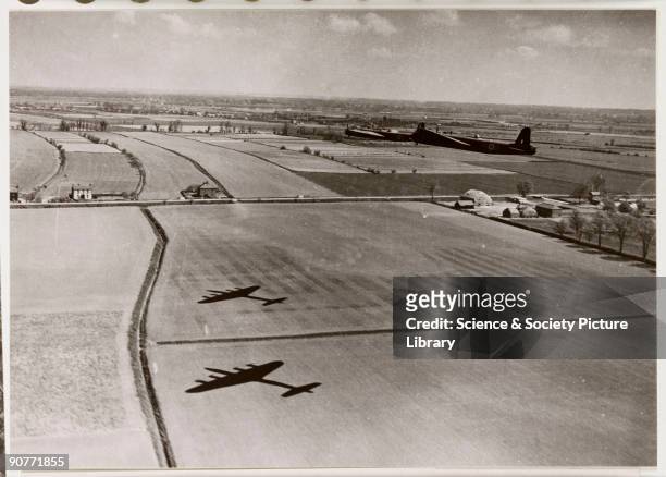 Photograph of two Royal Air Force Short Stirlings flying low over fields, taken by an unknown photographer during the Second World War.