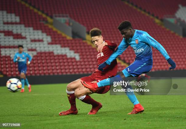 Bukayo Saka scores Arsenal's 2nd goal under pressure from Rhys Williams of Liverpool during the FA Youth Cup 4th Round match between Liverpool and...