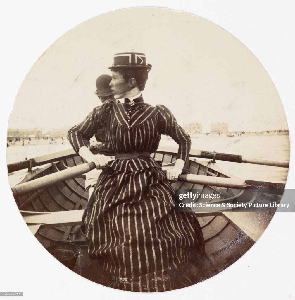 Woman in a rowing boat, c 1890.