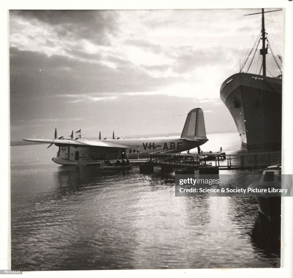 Flying boat moored at a jetty, c 1935.