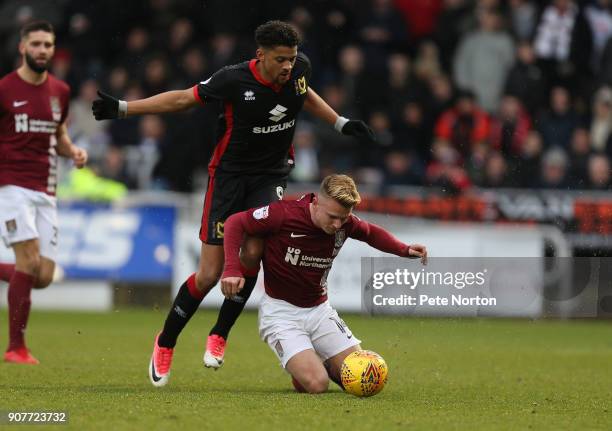 Sam Hoskins of Northampton Town goes to groung under the challenge from Osman Sow of Milton Keynes Dons during the Sky Bet League One match between...