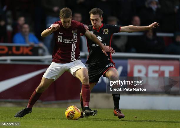 Sam Foley of Northampton Town controls the ball under pressure from Callum Brittain of Milton Keynes Dons during the Sky Bet League One match between...