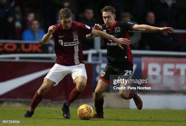 Sam Foley of Northampton Town controls the ball under pressure from Callum Brittain of Milton Keynes Dons during the Sky Bet League One match between...