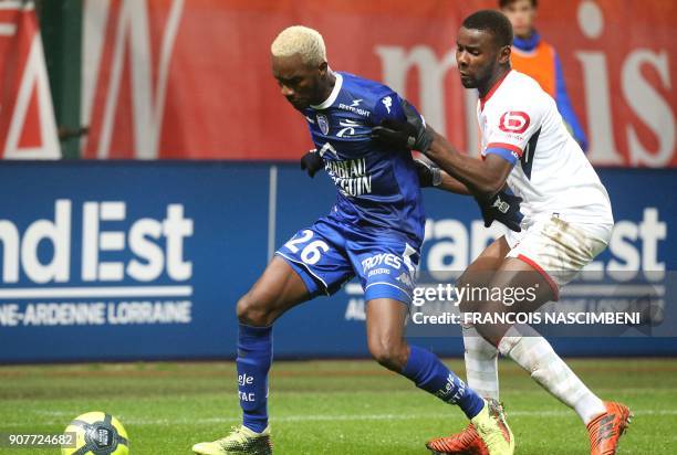 Troyes' Malian forward Adama Niane vies with Lille's defender Ibrahim Amadou during the French L1 football match between Troyes and Lille on January...