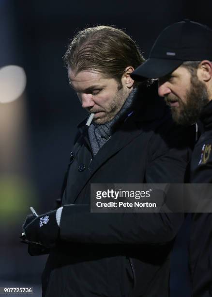 Milton Keynes Dons manager Robbie Neilson makes notes during the Sky Bet League One match between Northampton Town and Milton Keynes Dons at...