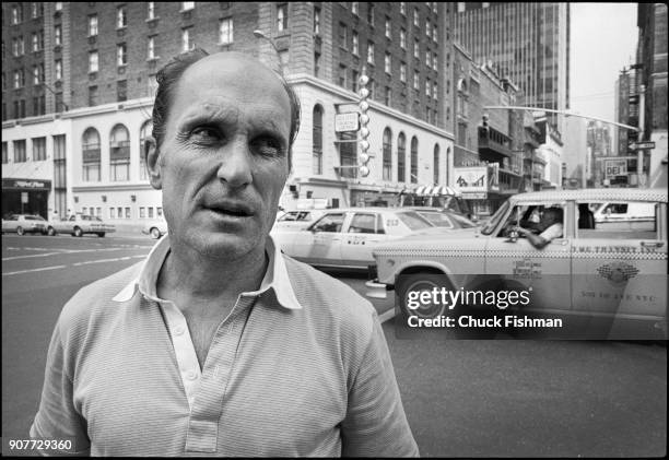 View of American actor and film director Robert Duvall as he stands at the intersection of 8th Avenue and 44th Street, New York, New York, July 1981....