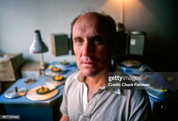 Portrait of American actor and film director Robert Duvall as he sits in a film editing suite, New York, New York, July 1981. Behind him is Steenbeck...