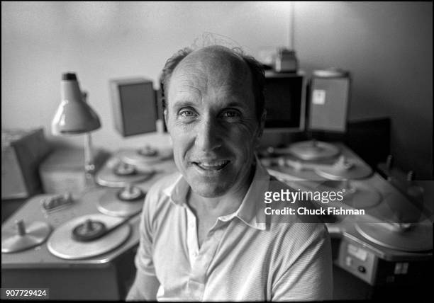 Portrait of American actor and film director Robert Duvall as he sits in a film editing suite, New York, New York, July 1981. Behind him is Steenbeck...