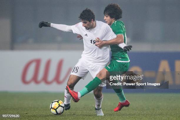 Suleiman Abu Zam'a of Jordan fights for the ball with Safaa Hadi of Iraq during the AFC U23 Championship China 2018 Group C match between Iraq and...
