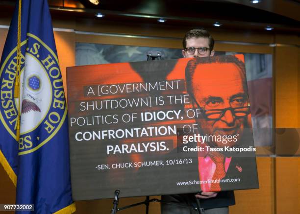 Staffer sets up a sign quoting Chuck Schumer for a presser for U.S. Rep. Cathy McMorris Rodgers on Capitol Hill on January 20, 2018 in Washington,...