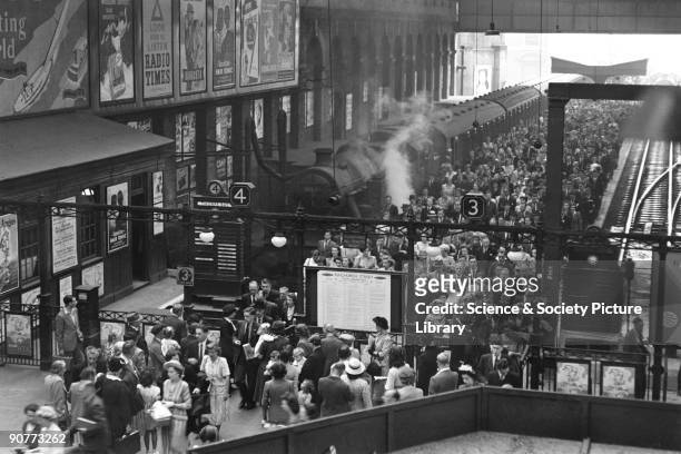 Passengers leaving a train at Liverpool Street station at 9.00 am on 29 June 1949. This station was the busiest terminus in London at this time....